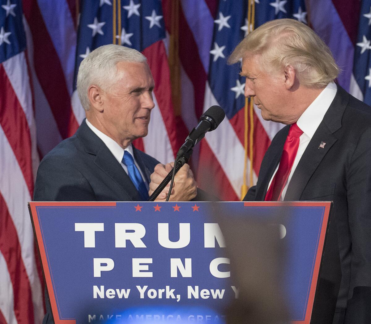 Mike Pence, left, and President Trump celebrate on election night in 2016.