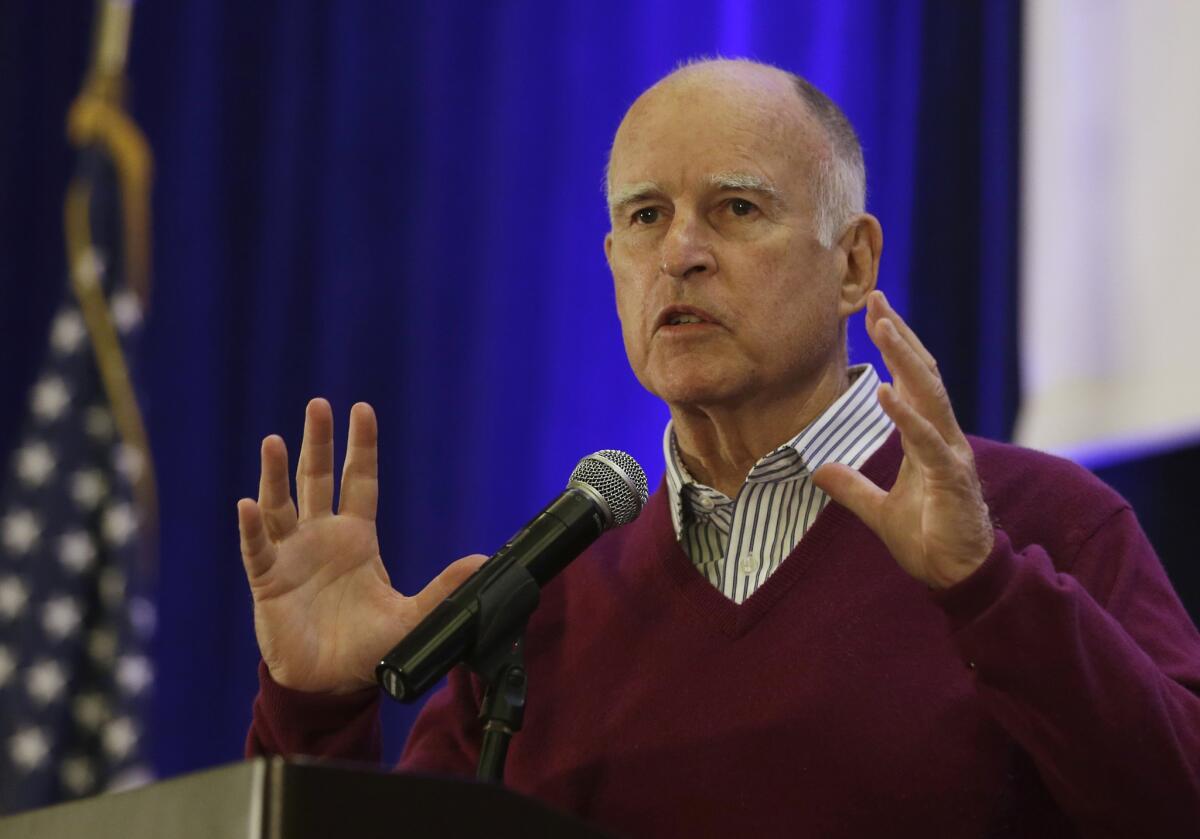 Gov. Jerry Brown speaks at the Assn. of California Water Agencies conference in Sacramento on May 6. State regulators have ordered communities to slash water use by as much as 36%.