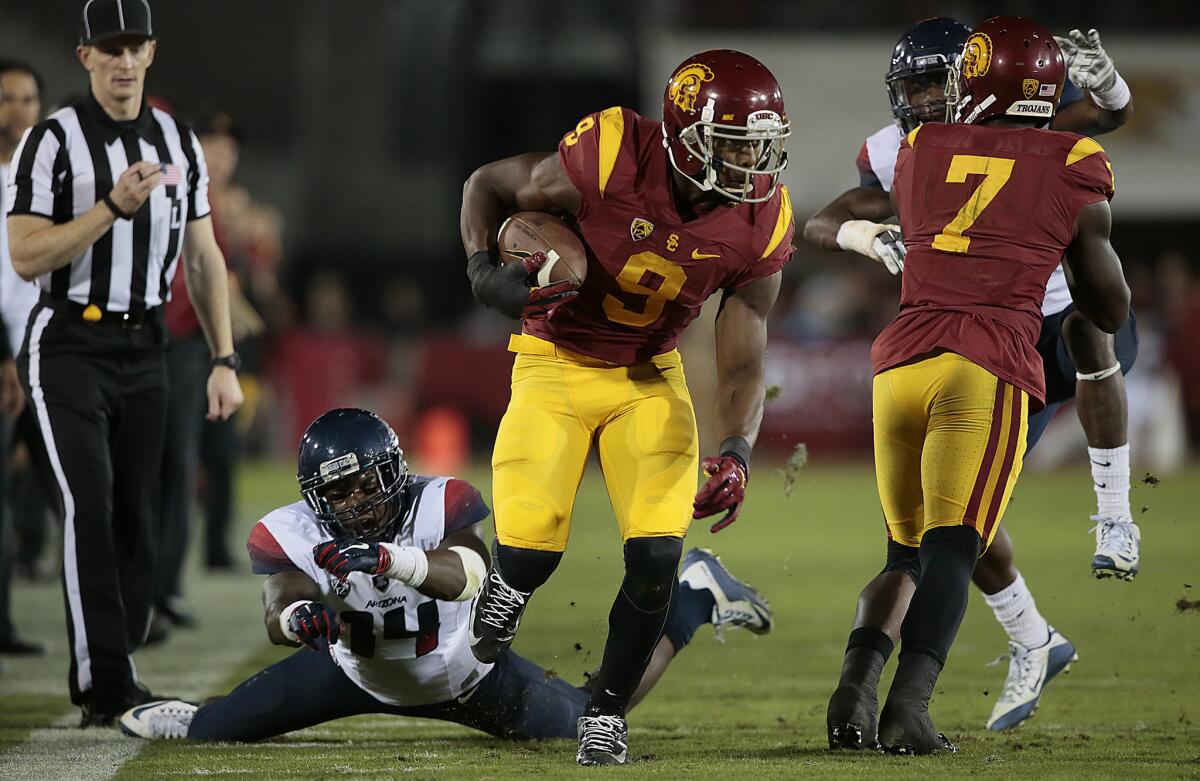 USC receiver JuJu Smith-Schuster sprints past Arizona defender Paul Magloire Jr. for a 72-yard touchdown on a long catch and run during the second quarter of Saturday's game.