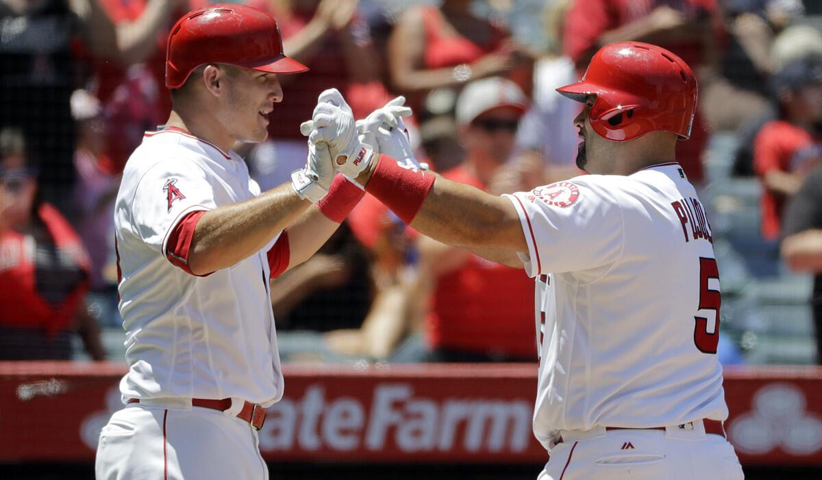 Angels' Albert Pujols, right, celebrates his two-run home run with Mike Trout during the fourth inning against the Chicago White Sox on Sunday.