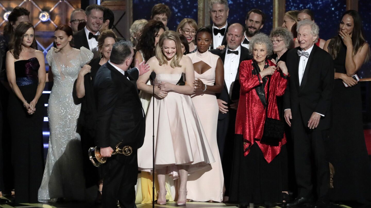 Bruce Miller and the cast congratulates Elisabeth Moss of "The Handmaid's Tale" after they won drama series.
