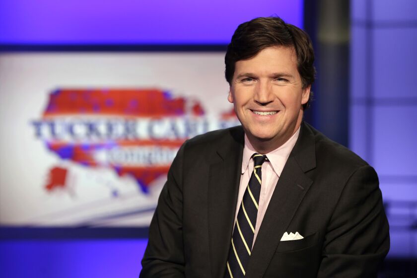 Tucker Carlson, host of "Tucker Carlson Tonight," poses for photos in a Fox News Channel studio, in New York, Thursday, March 2, 2017. (AP Photo/Richard Drew)