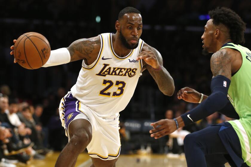 LOS ANGELES, CALIFORNIA - DECEMBER 08: LeBron James #23 of the Los Angeles Lakers drives around Robert Covington #33 of the Minnesota Timberwolves during the second half at Staples Center on December 08, 2019 in Los Angeles, California. NOTE TO USER: User expressly acknowledges and agrees that, by downloading and or using this photograph, User is consenting to the terms and conditions of the Getty Images License Agreement. (Photo by Katharine Lotze/Getty Images)