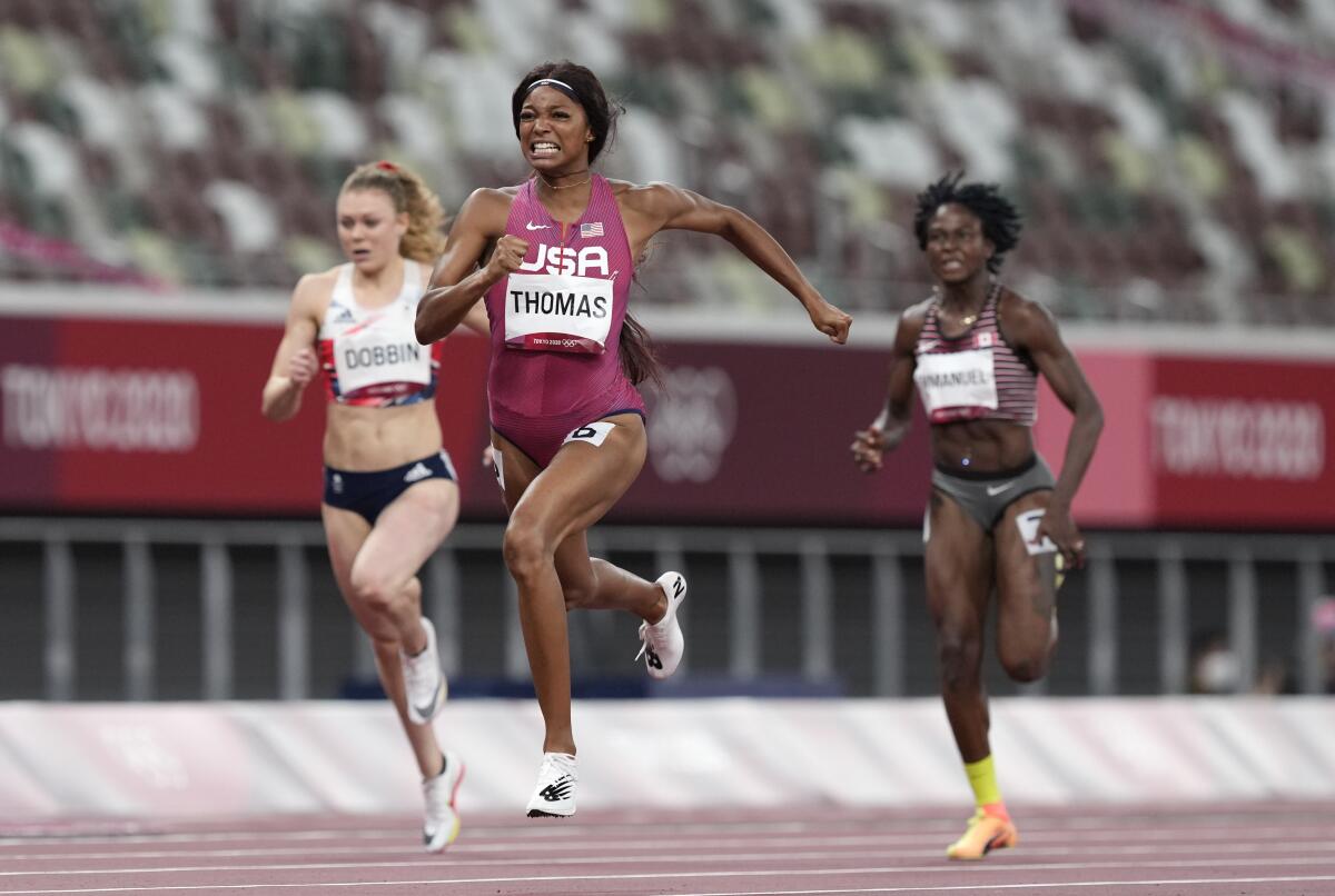 Gabrielle Thomas runs ahead of two opponents.