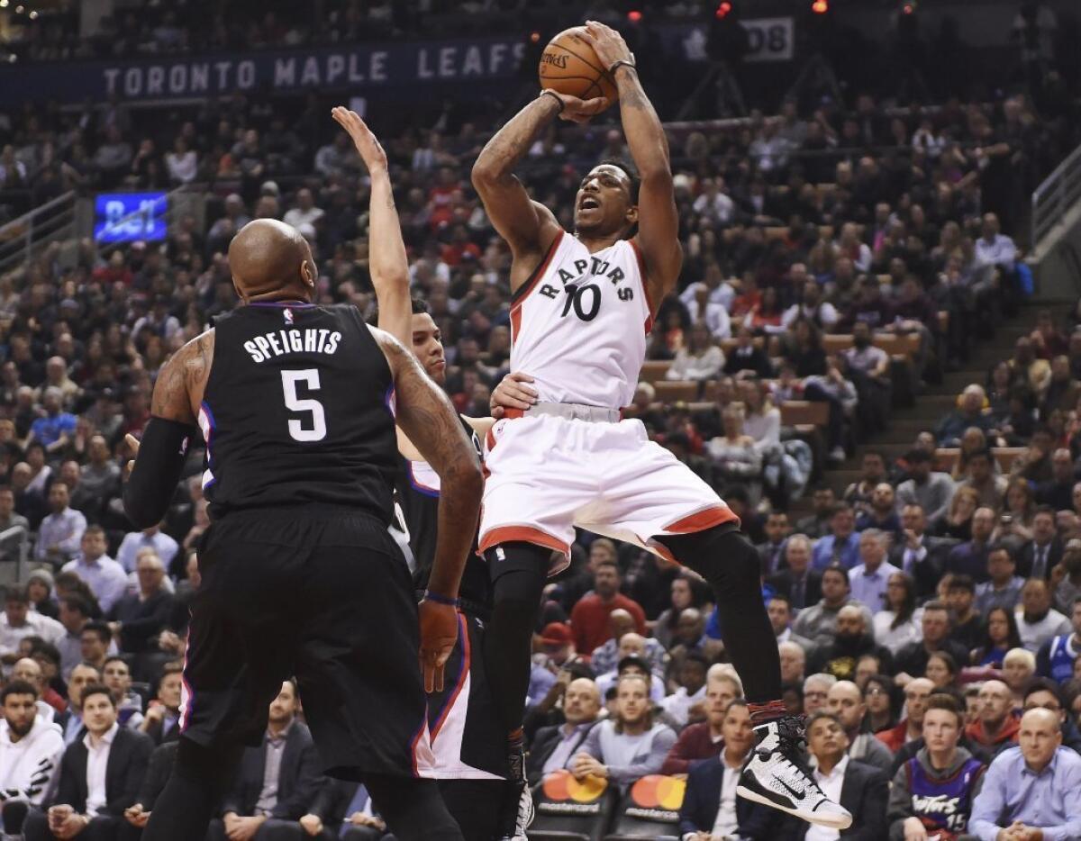 Toronto Raptors guard DeMar DeRozan shoots over Clippers center Marreese Speights in the first half.