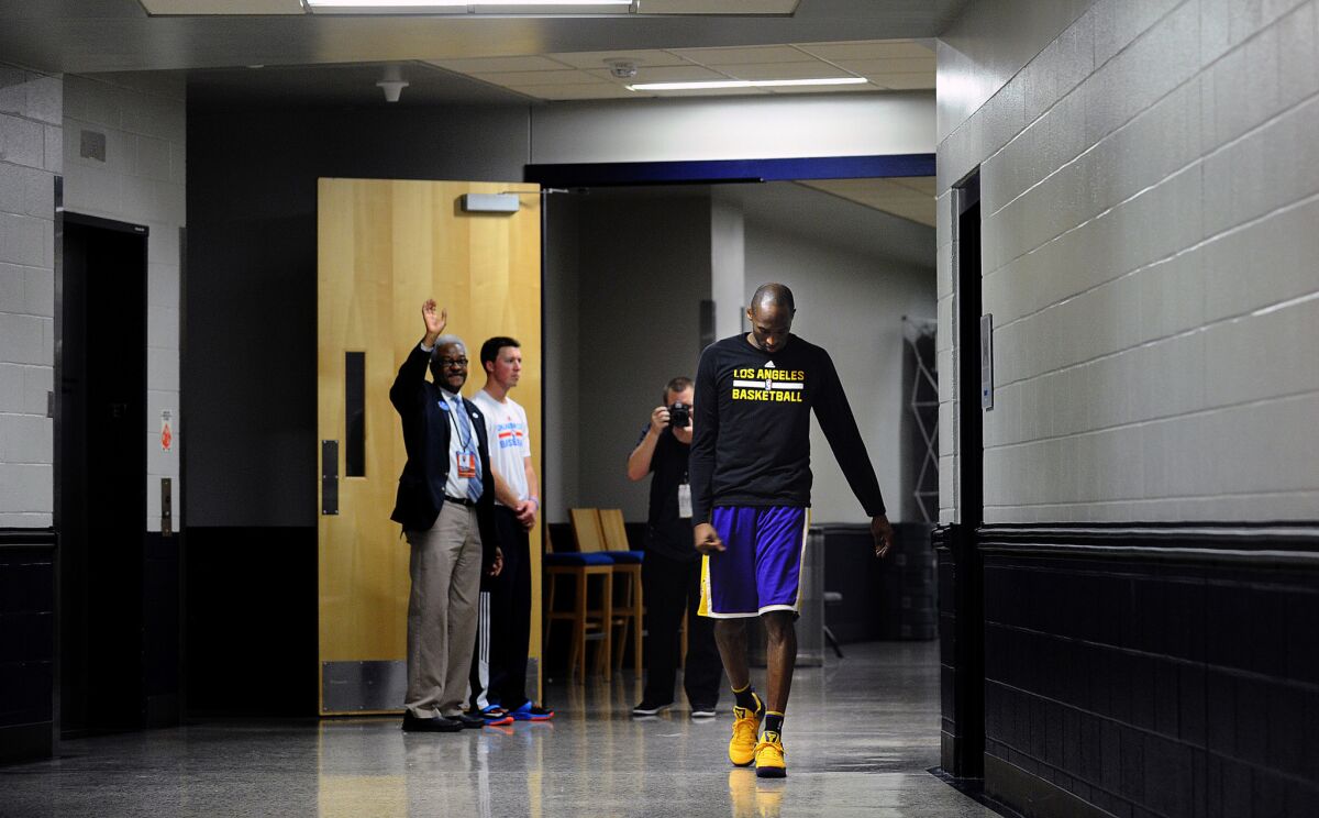 Lakers forward Kobe Bryant walks down the hallway to an opposing team's court for the final time after halftime against the Thunder.