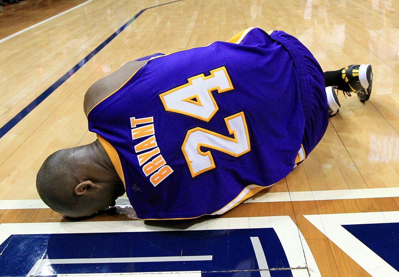 Lakers guard Kobe Bryant lays on the court after spraining his left ankle when landing awkwardly following a shot in the final seconds of the game Wednesday night in Atlanta.