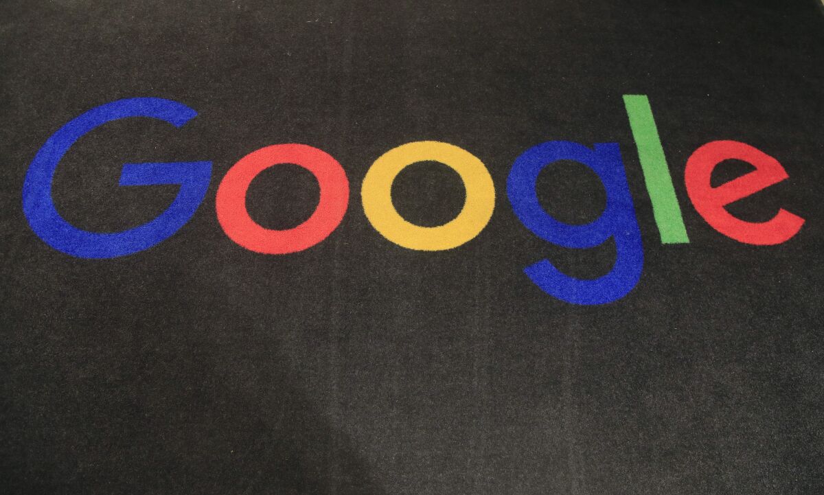 FILE - In this Monday, Nov. 18, 2019, file photo, the logo of Google is displayed on a carpet at the entrance hall of Google France in Paris. South Korea’s competition watchdog says it plans to fine Google at least 207.4 billion won ($177 million) for allegedly blocking smartphone makers like Samsung from using other operating systems, in what would be one of the country's biggest antitrust penalties ever. (AP Photo/Michel Euler, File)