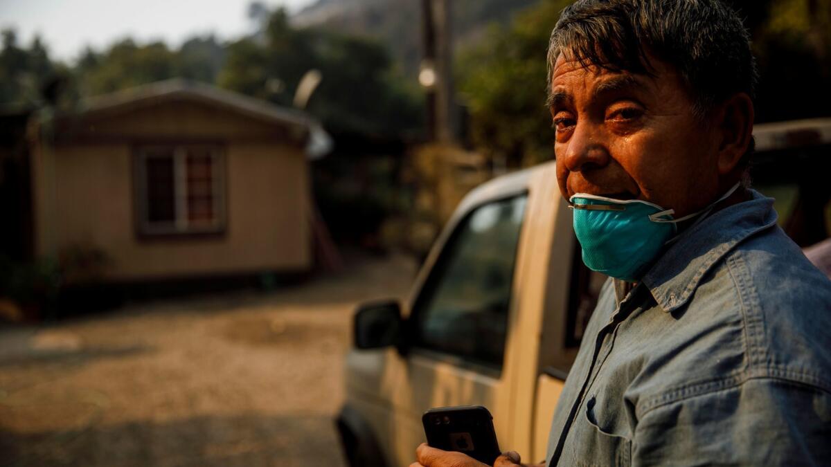 Arnulfo Basave wept and prayed on Monday after discovering that his Carpinteria trailer home was still spared from the Thomas fire.