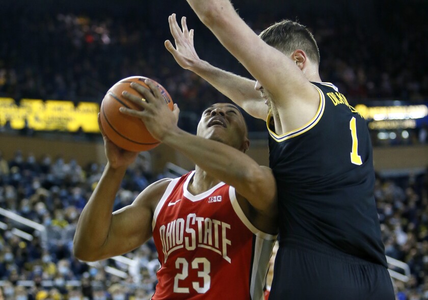 Ohio State forward Zed Key (23) tries taking a shot against Michigan center Hunter Dickinson (1) during the first half of an NCAA college basketball game Saturday, Feb. 12, 2022, in Ann Arbor, Mich. (AP Photo/Duane Burleson)