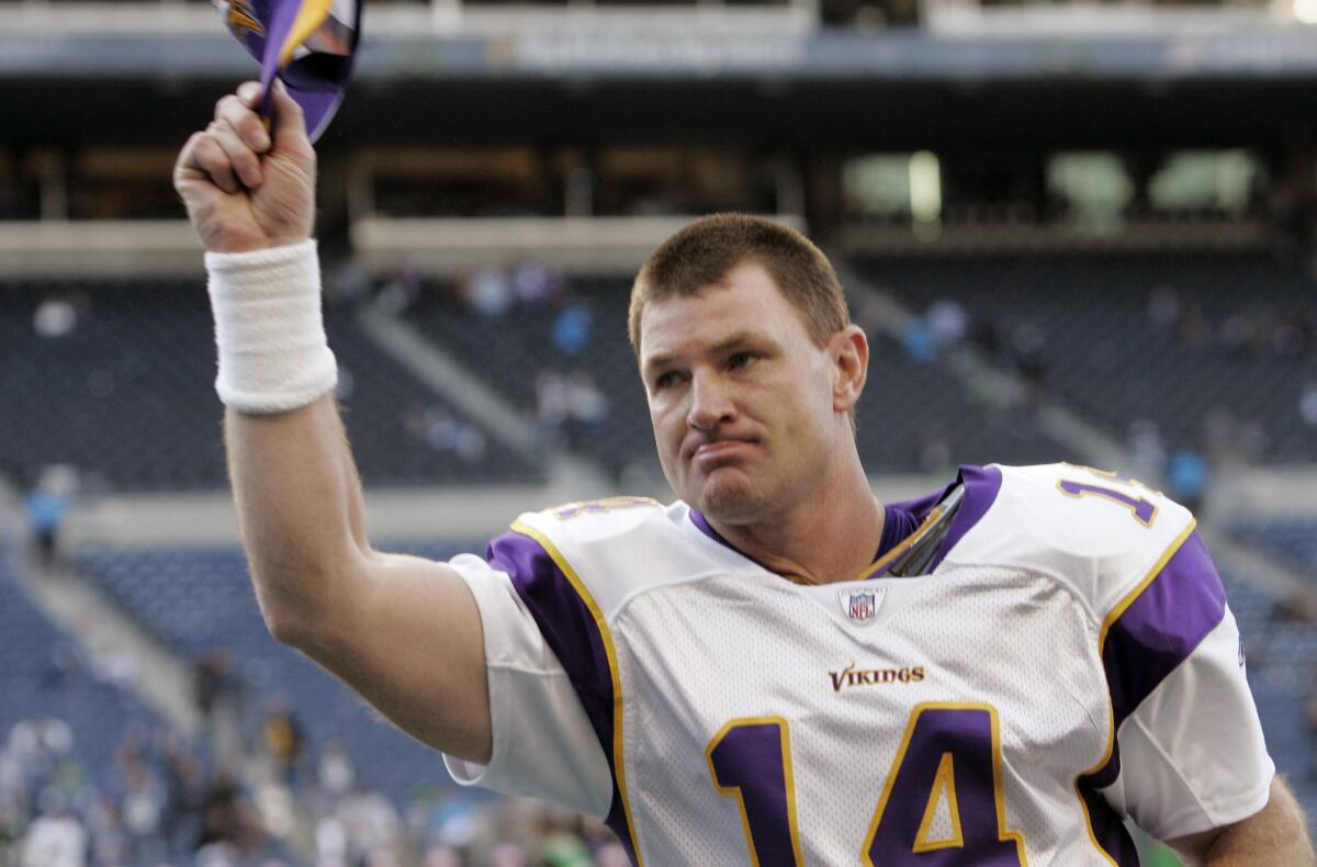 Minnesota Vikings quarterback Brad Johnson tips his cap to fans as he leaves the field.