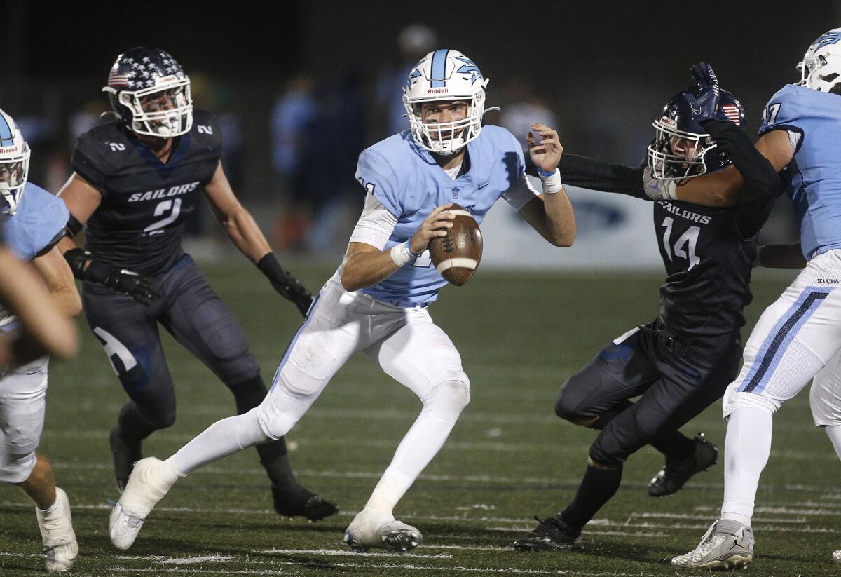 Corona del Mar quarterback Kaleb Annett tries to find a receiver during the Battle of the Bay against Newport Harbor.