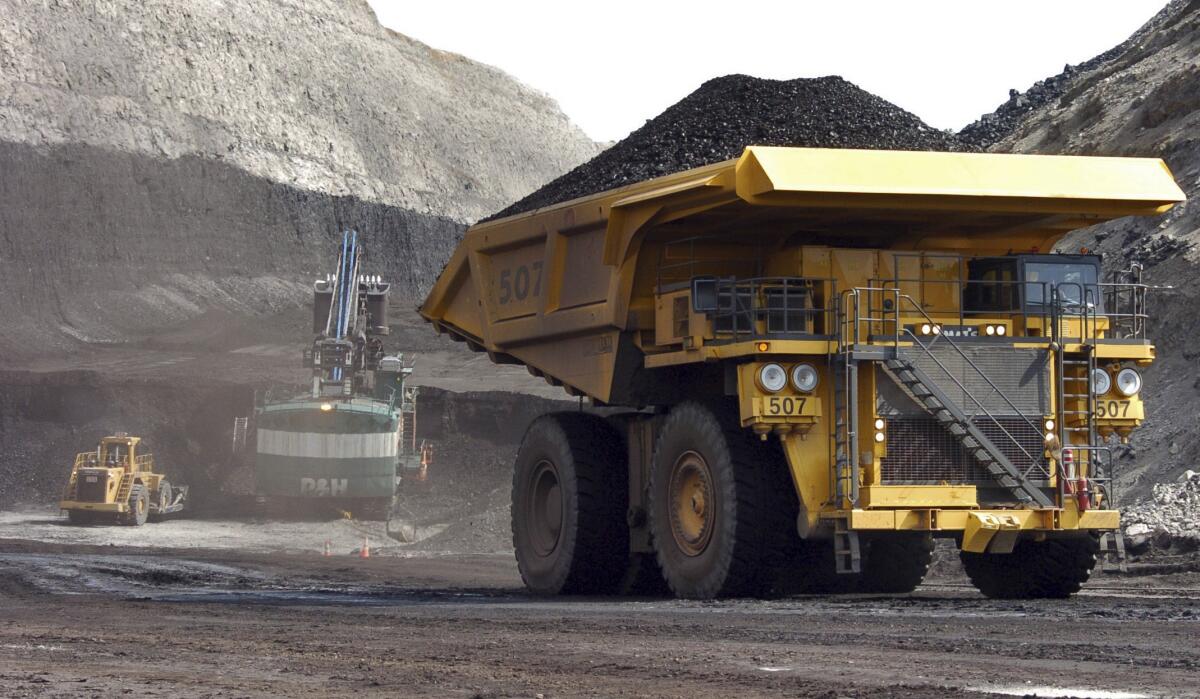 A truck carrying 250 tons of coal hauls the fuel to the surface of the Spring Creek mine near Decker, Mont., in 2013.