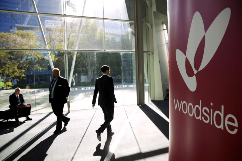 Shareholders arrive for the Woodside Petroleum General Meeting held at the Perth Convention and Exhibition Centre, Aug. 8, 2014. Australia’s Woodside Petroleum said Thursday, Jan. 27, 2022, is withdrawing from projects in strife-torn Myanmar, following a similar decision last week by Total and Chevron. (Richard Wainwright/AAP Image via AP)