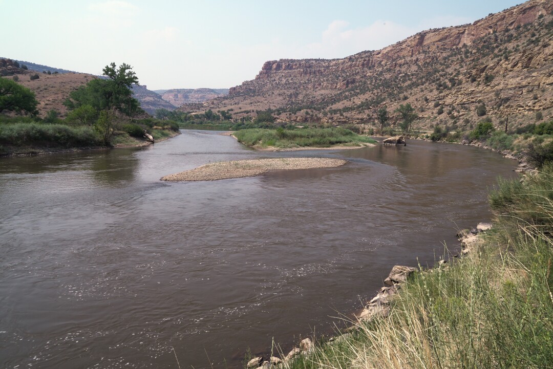 The Colorado River flows slowly northeast of Palisade, Colo., on Monday, July 12, 2021. 