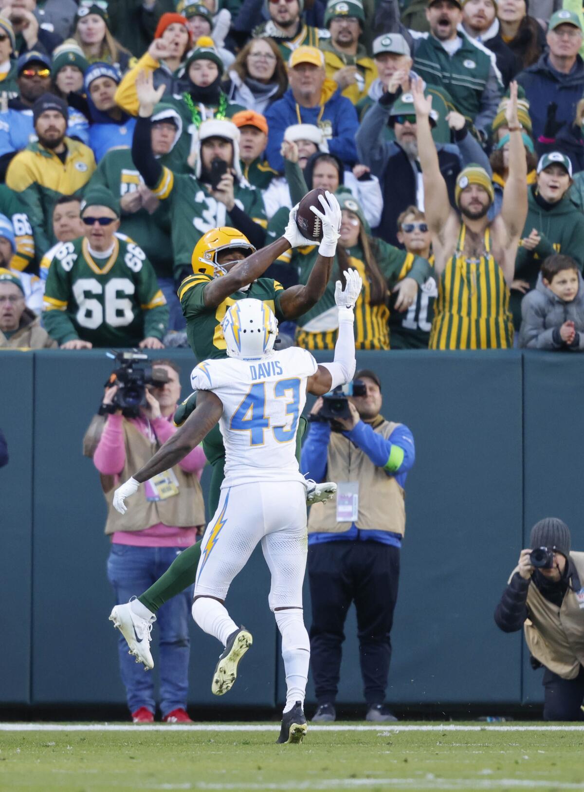 Packers receiver Romeo Doubs (87) catches the deciding touchdown pass behind Chargers corner Michael Davis. 