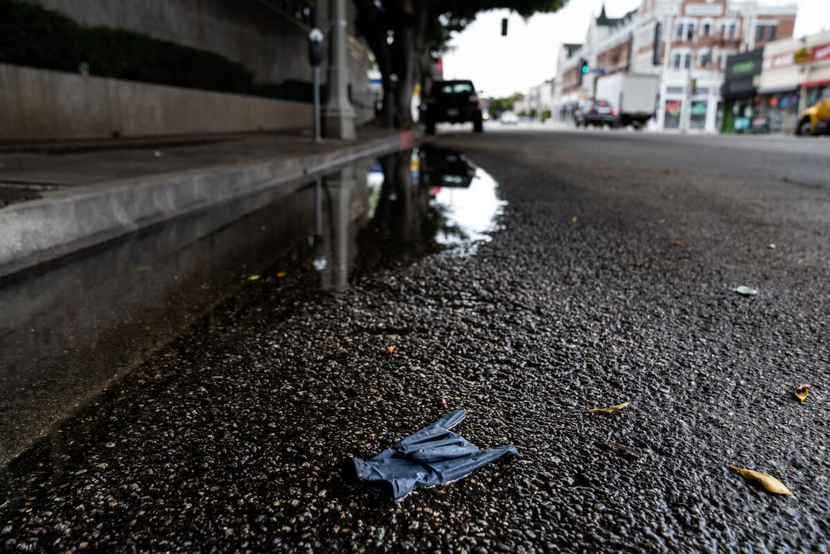 A discarded nitrile glove mimicking the Hawaiian "shaka" is seen left on the street in Hollywood.