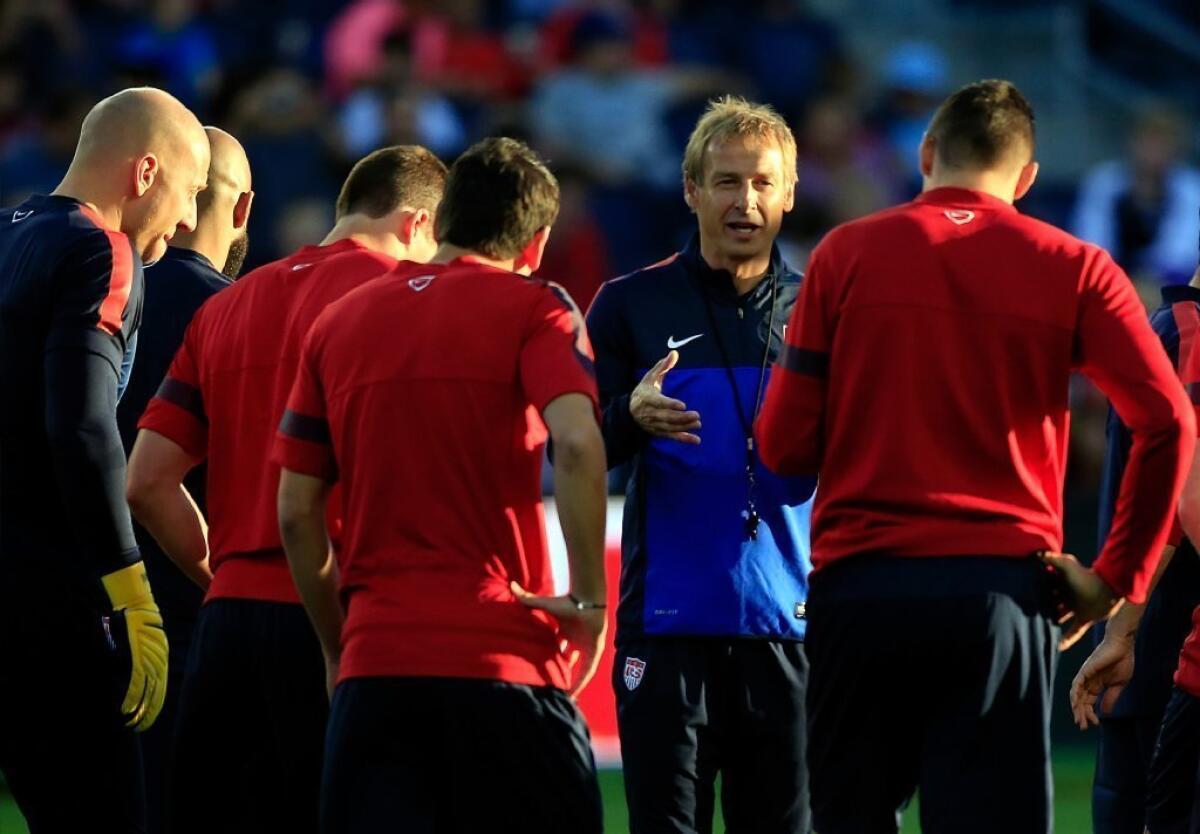 Juergen Klinsmann talks with players during a training session on Oct. 9.