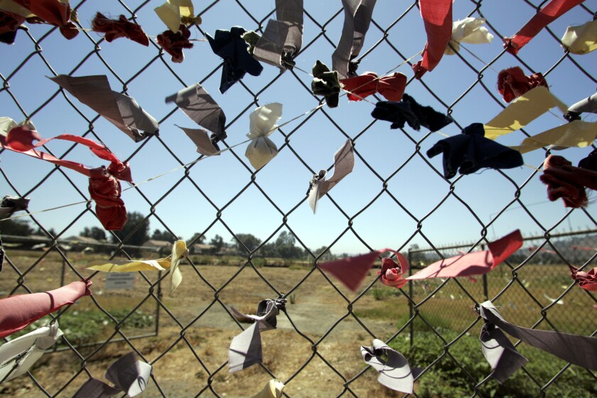 Colored ribbons placed by Juanenos Indians surround sacred burial ground in San Juan Capistrano in 2004. For years, tribe members have fought for access to the gravesite of their ancestors.