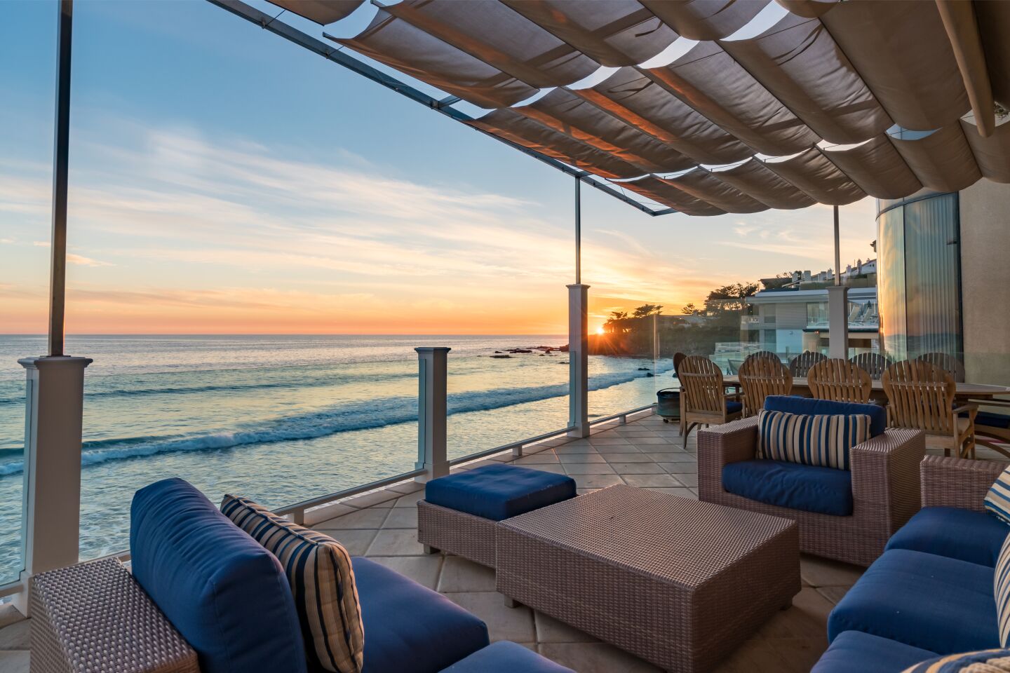 The covered furnished deck overlooks the ocean.