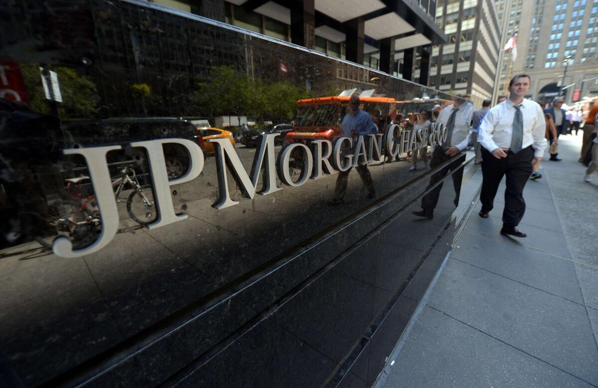 This file photo taken on August 14, 2013 shows people walking by JP Morgan Chase & Company headquarters in New York.