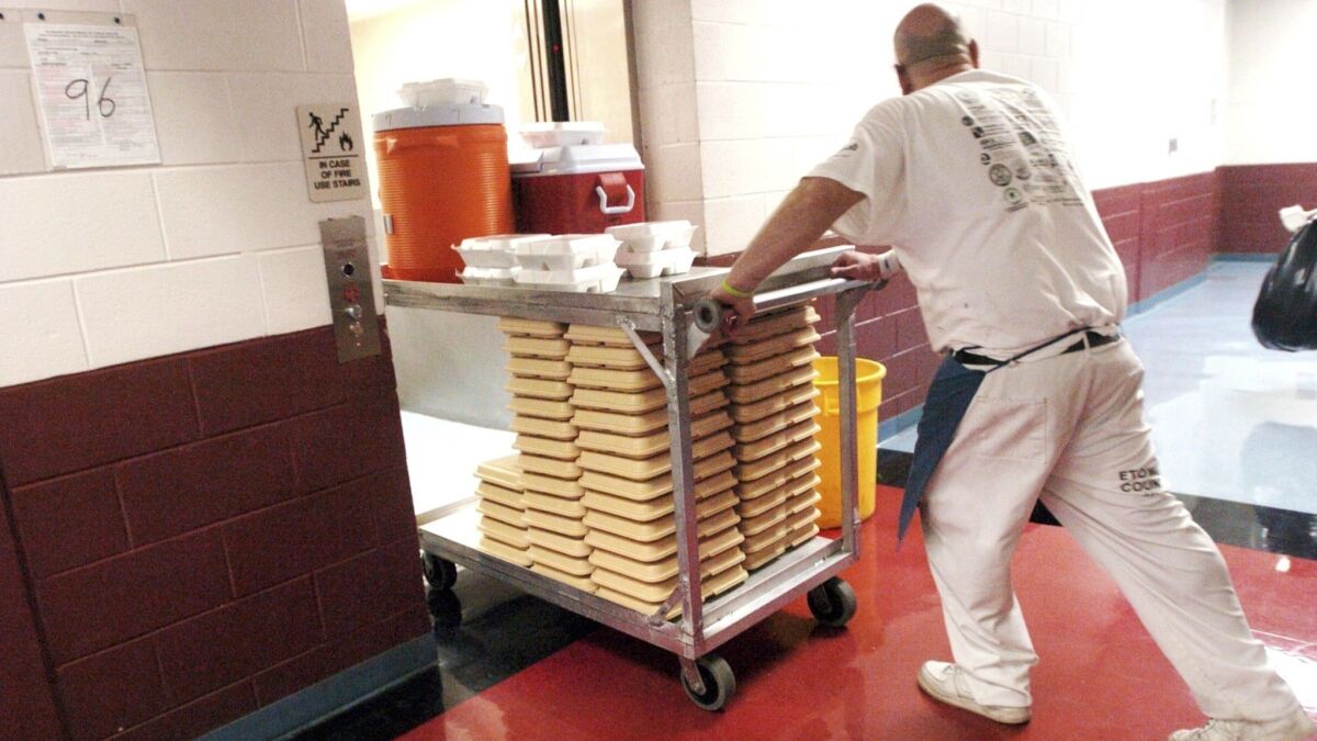 Lunch is delivered to prisoners at the Etowah County Detention Center in Gadsden, Ala., in June 2010. For decades, Alabama sheriffs have made money by feeding prisoners for only pennies per meal and pocketing leftover reimbursement funds.