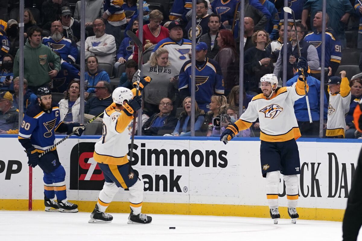 Nashville Predators' Matt Duchene, right, is congratulated by teammate Roman Josi after scoring the game-winning goal in overtime as St. Louis Blues' Ryan O'Reilly (90) watches during an NHL hockey game Thursday, Nov. 11, 2021, in St. Louis. (AP Photo/Jeff Roberson)