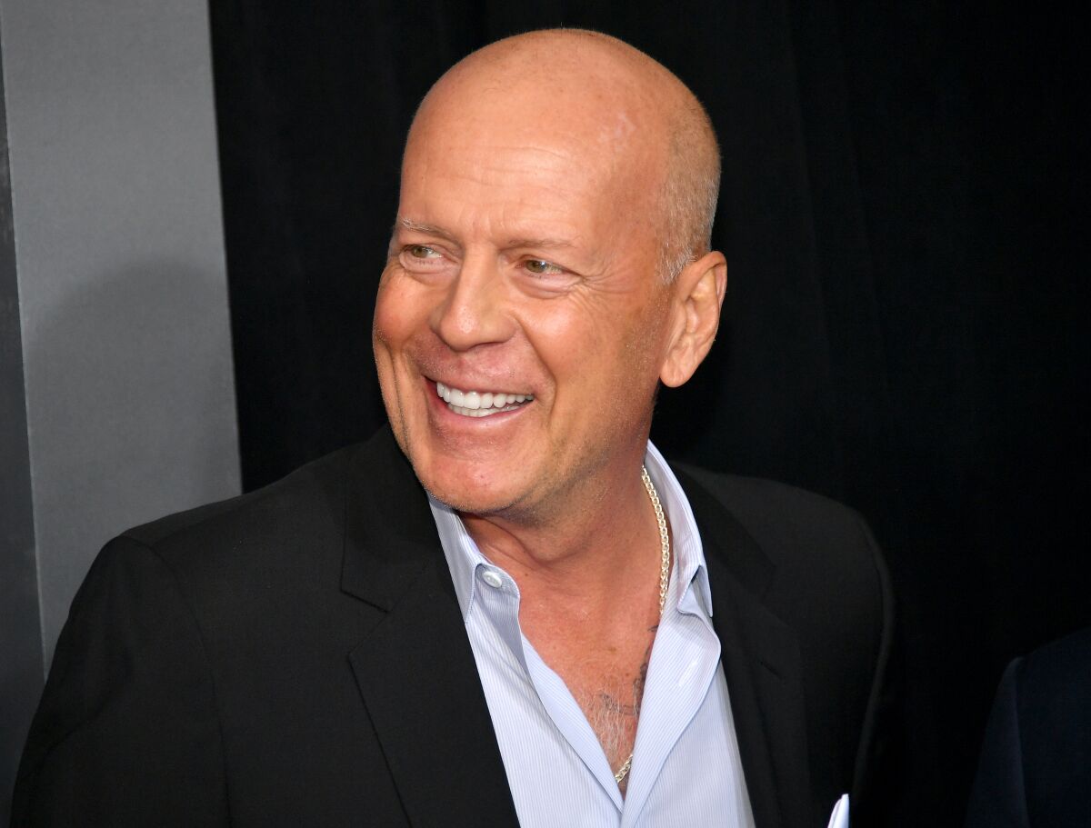 Bruce Willis smiles at a movie premiere