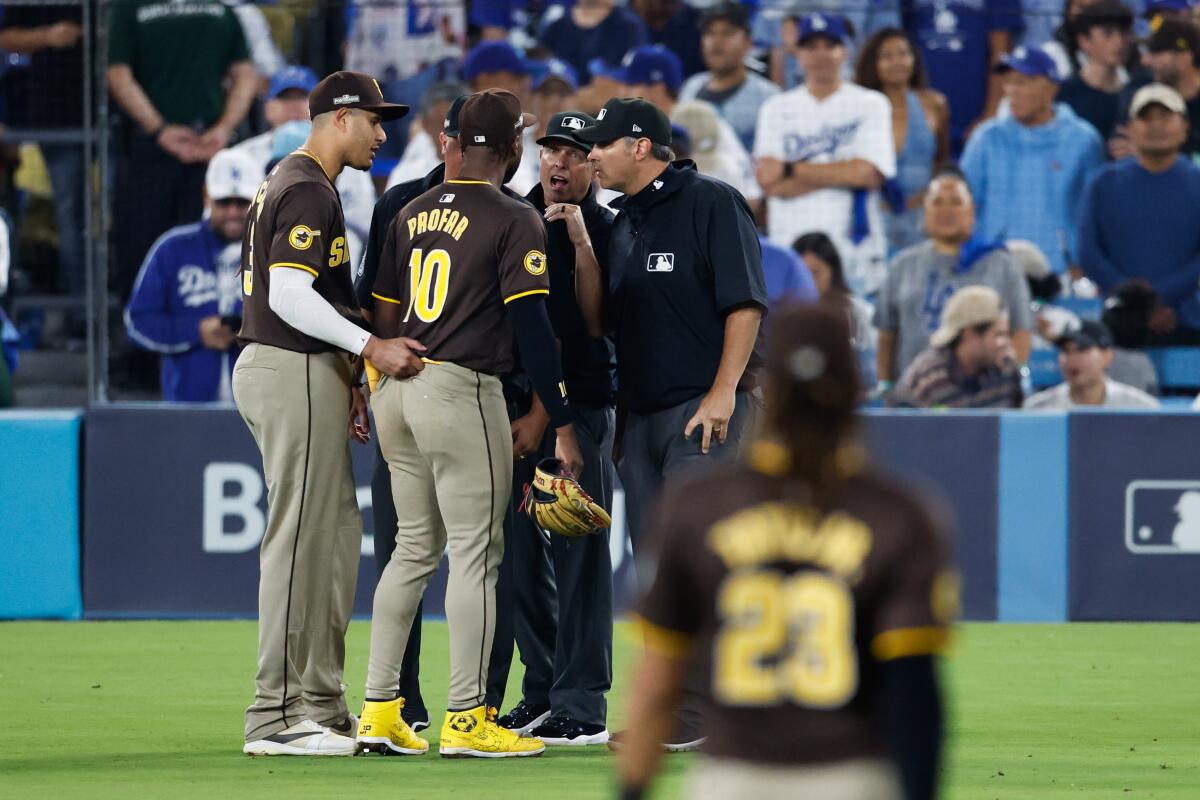 San Diego Padres left fielder Jurickson Profar (10) and his teammates talk with umpires during the seventh inning.