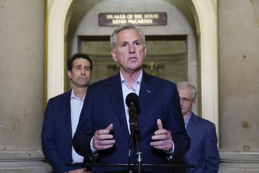 House Speaker Kevin McCarthy of Calif., speaks during a news conference after President Joe Biden and McCarthy reached an "agreement in principle" to resolve the looming debt crisis on Saturday, May 27, 2023, on Capitol Hill in Washington. Rep. Patrick McHenry, R-N.C., a key Republican in the debt limit negotiations and chairman of the House Financial Services Committee, back right, and Rep. Garret Graves, R-La., McCarthy's top mediator in the debt limit talks, left, look on. (AP Photo/Patrick Semansky)