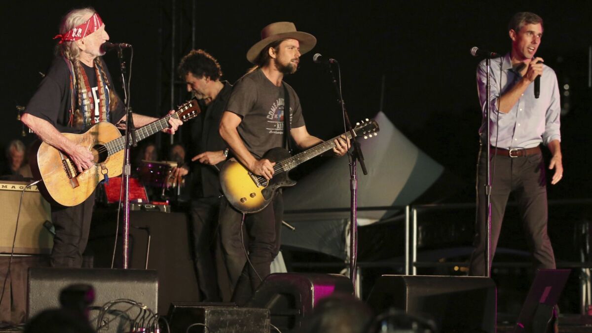 Willie Nelson, left, performs with his son Lukas and Rep. Beto O'Rourke (D-Texas) during the "Turn Out for Texas" concert and rally in Austin, where Nelson introduced his new song "Vote 'Em Out."