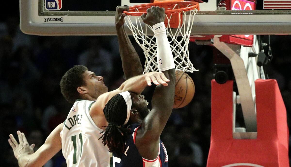 Clippers forward Montrezl Harrell against Bucks center Brook Lopez during the second half of their game Saturday.