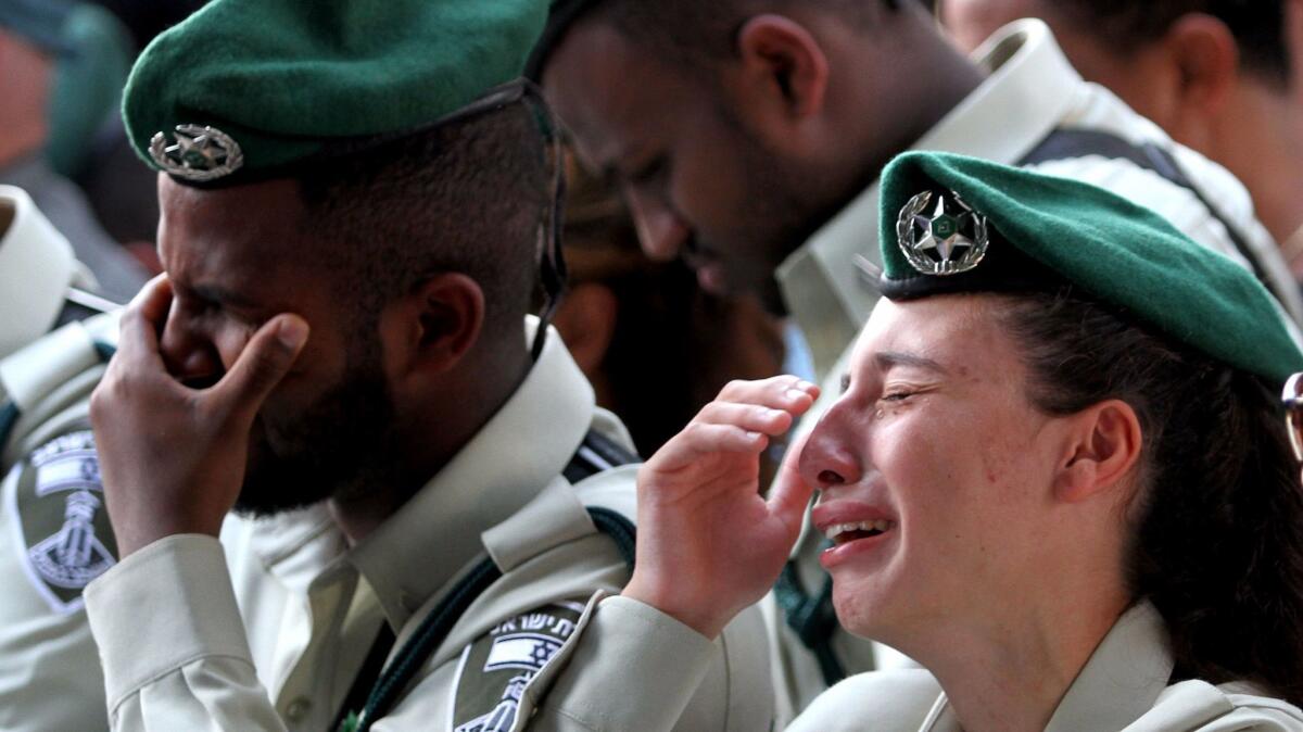 Israeli security forces mourn during the funeral of border police officer Solomon Gabariya, one of three Israeli guards killed in a shooting attack in the West Bank. The funeral was in Beer Yaakov, near Tel Aviv, on Sept. 26, 2017.
