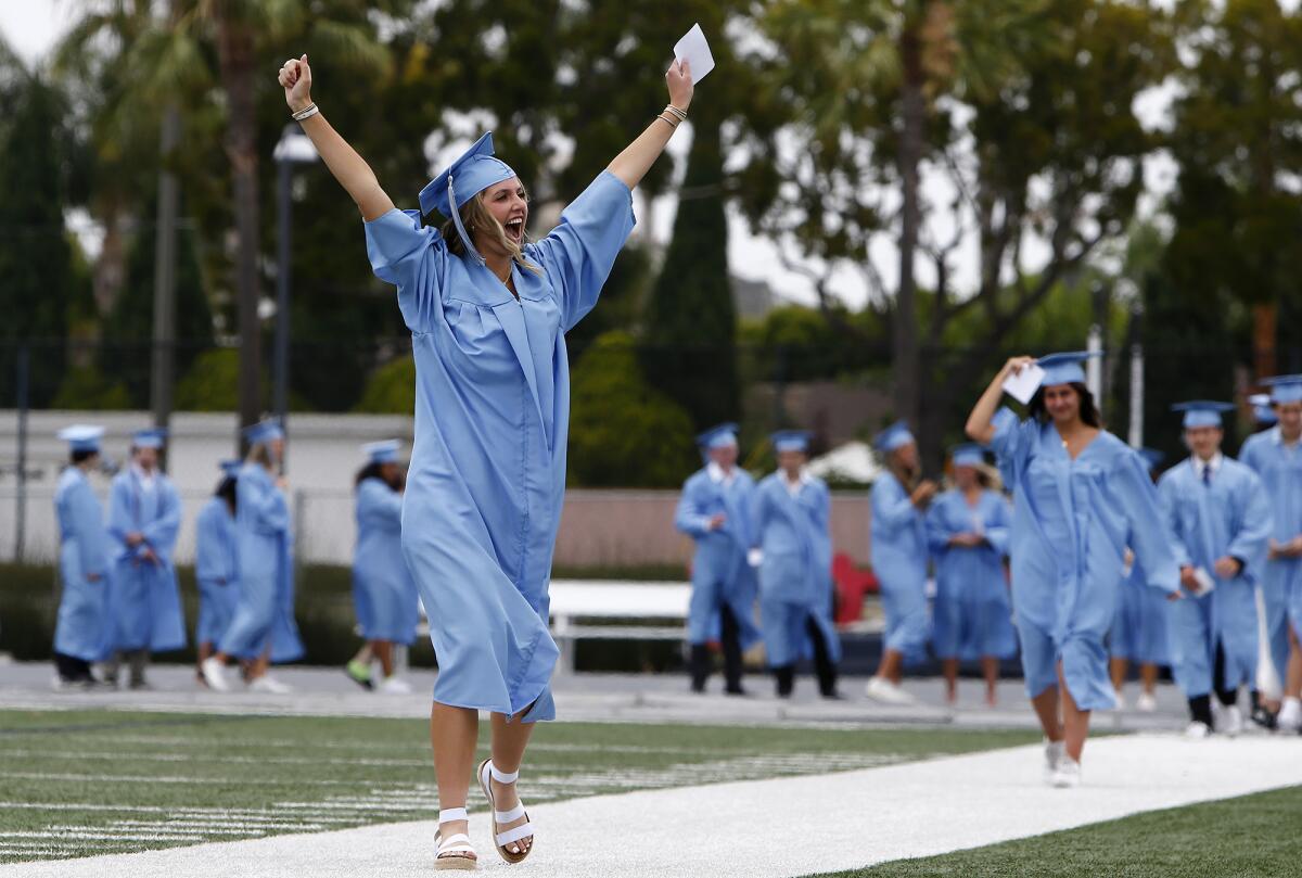 Amanda Cord cheers at family during Corona del Mar High's commencement ceremony.