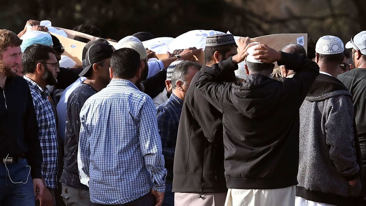 Mourners attend a funeral for victims of the mosque attacks at the Memorial Park cemetery in Christchurch, New Zealand, on March 20, 2019.