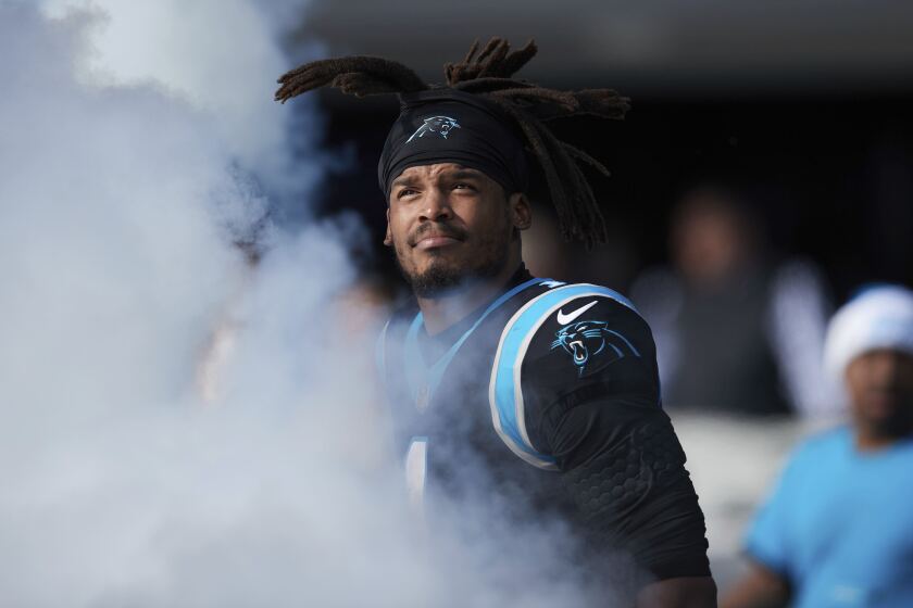 Carolina Panthers quarterback Cam Newton (1) enters the field through smoke during player introductions