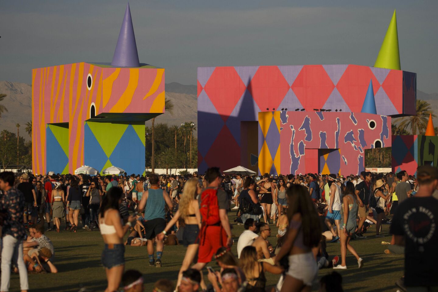 Coachella attendees walk on the fields past the art project "is this what brings things into focus?" by Joanne Tatham and Tom O'Sullivan, during weekend one of the three-day Coachella Valley Music and Arts Festival at the Empire Polo Grounds on Sunday, April 16, 2017 in Indio, Calif. (Patrick T. Fallon/ For The Los Angeles Times)