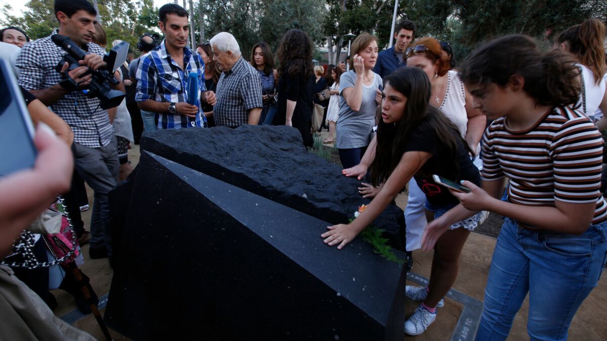Melani Nazarian, left, and Ashley Muradian view the first permanent monument in L.A. to memorialize the Armenian genocide after it was unveiled at Grand Park.