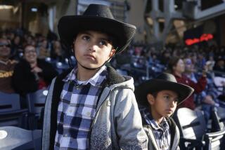 SAN DIEGO, CA - JANUARY 14, 2024: Mateo Sotero, 7, left, and his brother Issac Zamora, 8, who are from Tijuana, watch the San Diego Rodeo at Petco Park for in San Diego on Sunday, January 14, 2024.