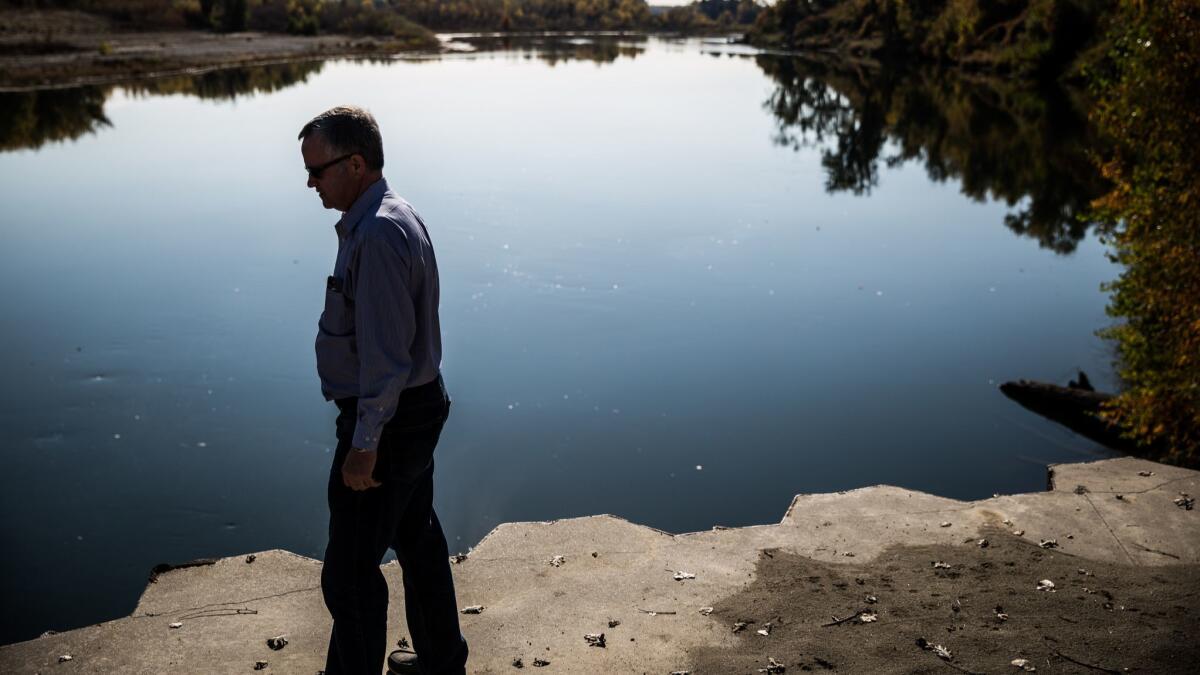 Jim Watson, general manager of the Sites Project Authority, stands in 2015 at the point in the Sacramento River where a pipeline would be built to fill the proposed Sites Reservoir near Maxwell, Calif.