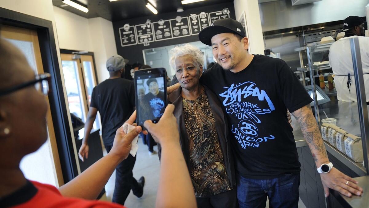 Tabitha O'Neal, left, takes a photo of her mother, Delores, with Chef Roy Choi before dining at Locol in January 2016.