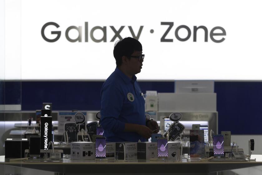 A man passes by Samsung Electronics Galaxy Note 7 smartphones at the company's shop in Seoul. Samsung Electronics has temporarily halted production of its Galaxy Note 7 after reports that they too could malfunction and explode.