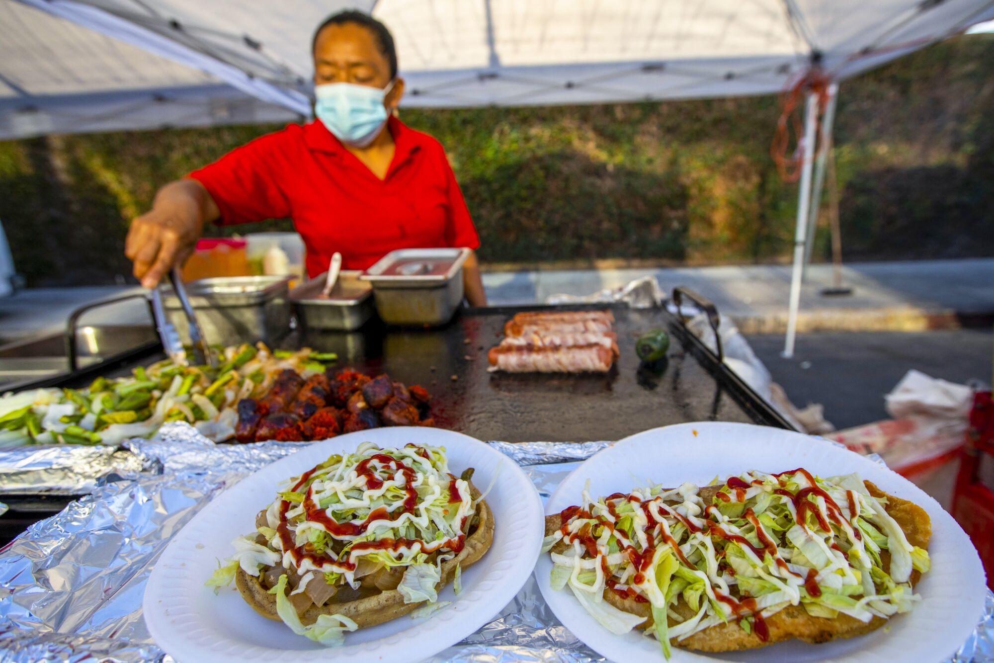 A woman prepares food at a market