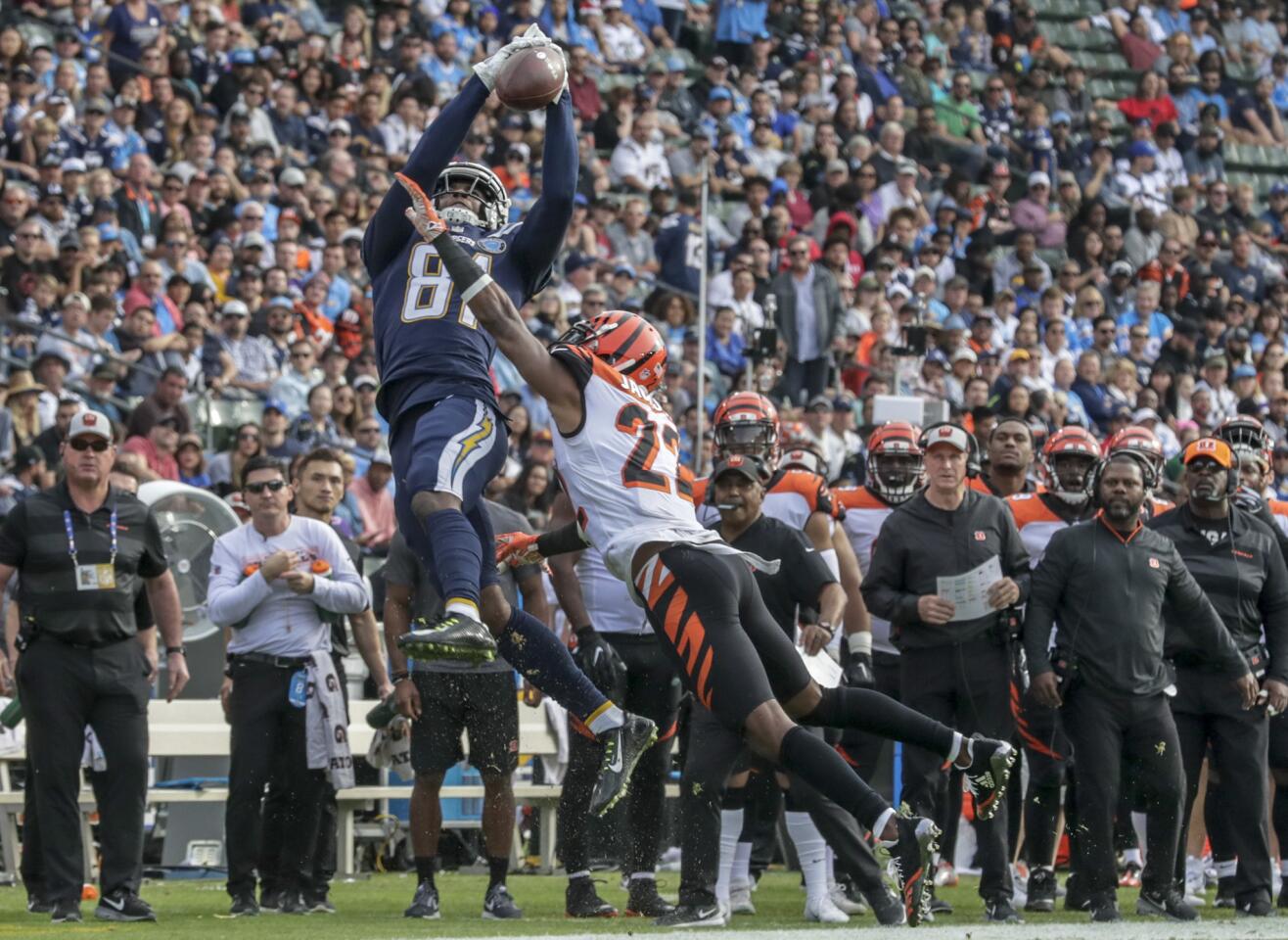 Chargers receiver Mike Williams reaches high for a pass over Bengals defensive back William Jackson, but the play was called incomplete because the ball hit the ground upon Williams landing.