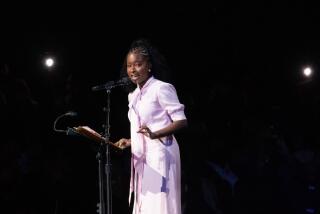 LOS ANGELES, CA - DECEMBER 11: Amanda Gorman, the National Youth Poet Laureate, delivers her poem during Karen Bass' inauguration ceremony at Microsoft Theater on Sunday, Dec. 11, 2022 in Los Angeles, CA. (Myung J. Chun / Los Angeles Times)