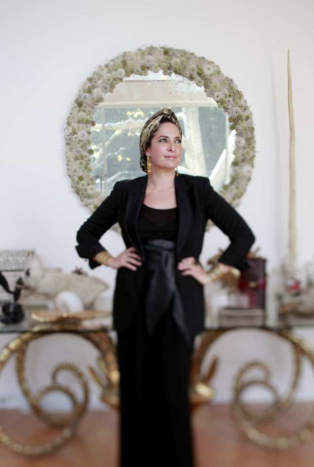 Designer Raven Kauffman wears a vintage Tom Ford suit and gold turban to get into the holiday spirit.