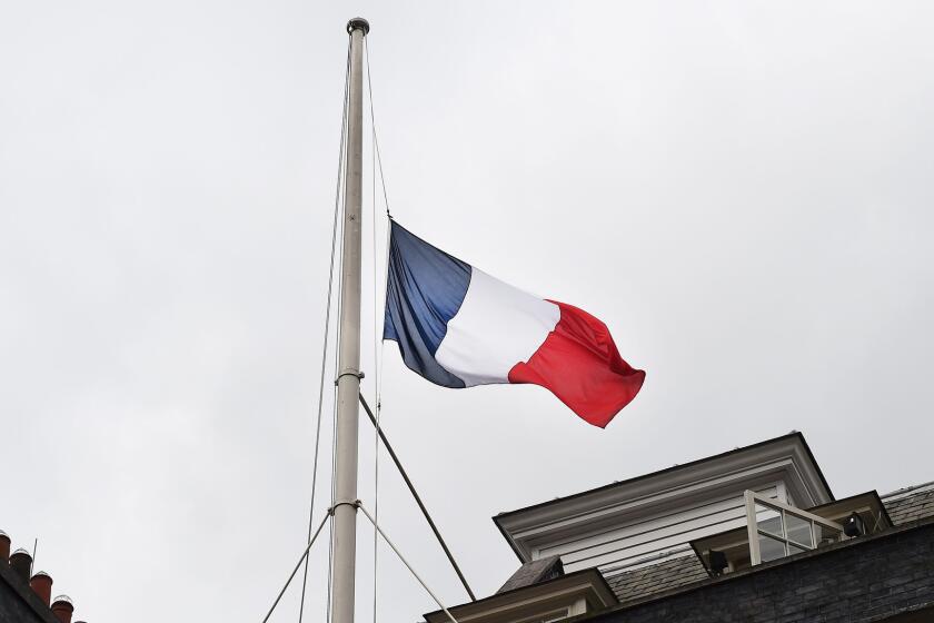 The French tricolor flag flies at half-staff over 10 Downing Street in London on July 15.