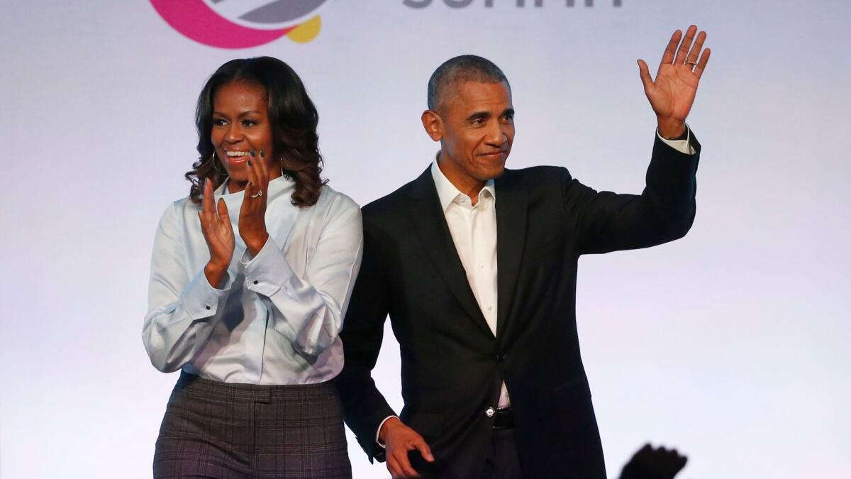 Former First Lady Michelle Obama and former President Obama and arrive for the Obama Foundation Summit in Chicago on Oct. 13.