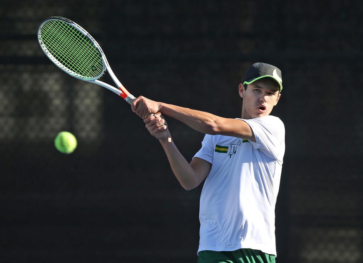 Jason You hits a backhand winner for Edison High in a singles set during Thursday's Wave League match at Laguna Beach.