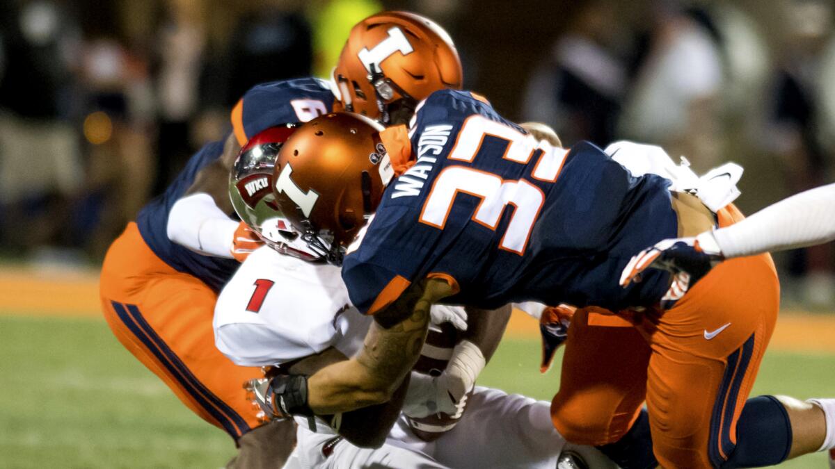 Illinois linebacker Tre Watson (33) makes helmet-to-helmet contract with Western Kentucky wide receiver Nacarius Fant (1) during a game earlier this season.
